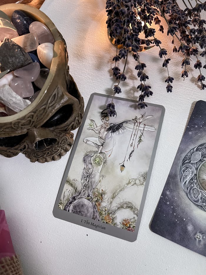 Magical tarot card setup featuring crystals, a skull, and dried lavender for mystical ambiance.