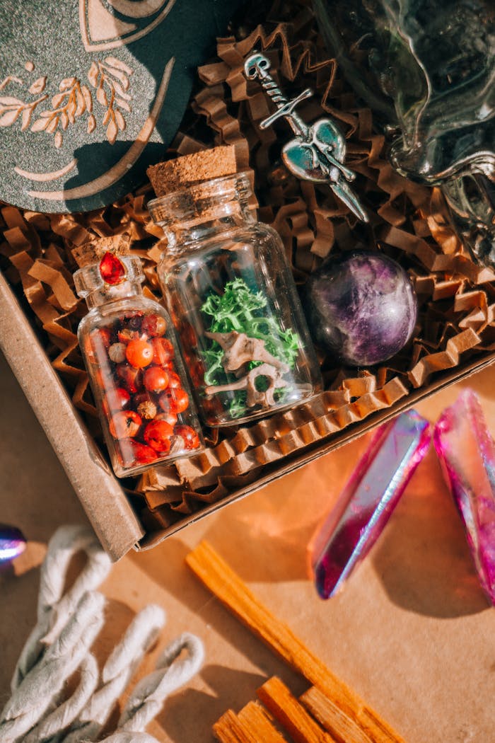 Flat lay of mystical items including bottles, crystals, and herbs in warm sunlight.
